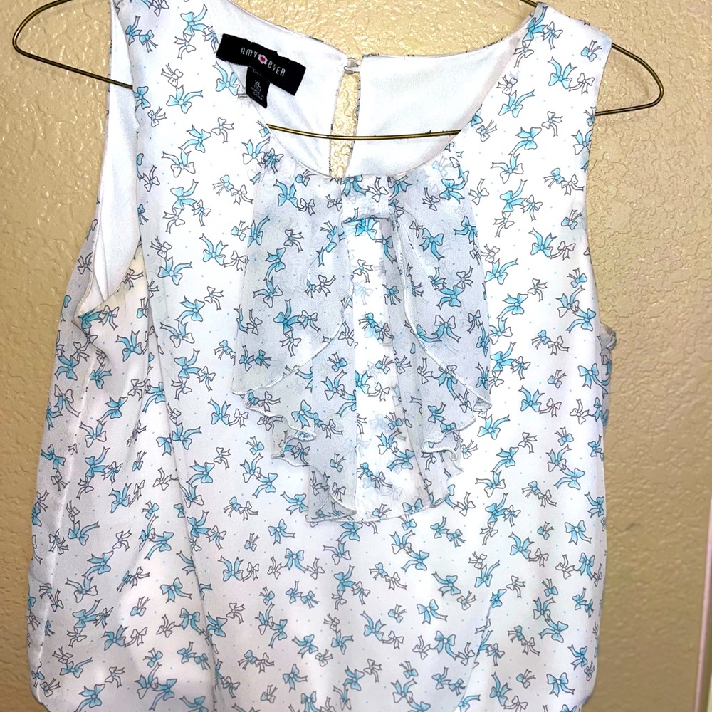Beautiful blue and white flowy tank top adorned with a bow around the collar!